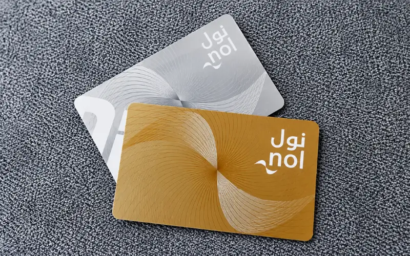 Gold and silver Nol Cards displayed on a textured surface.