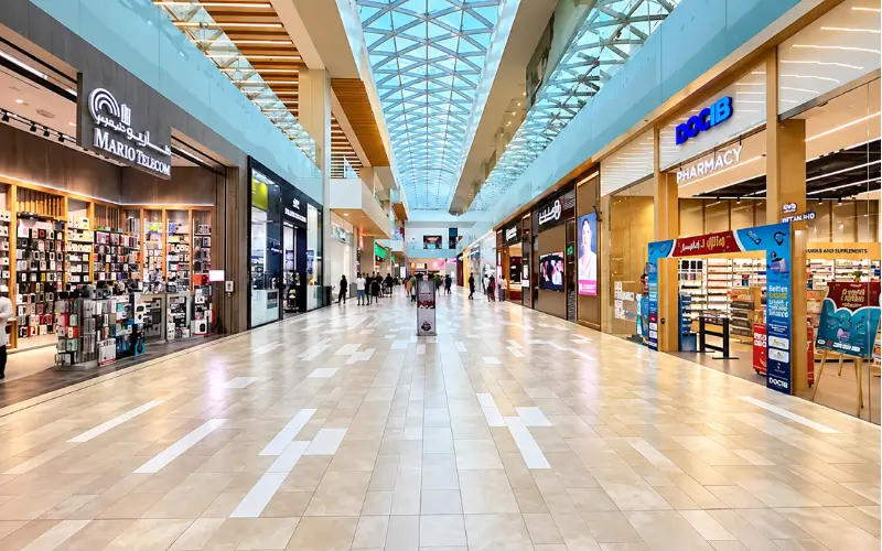 Silicon Central Mall interior with shops, skylight, tiled walkway, and bright modern lighting.