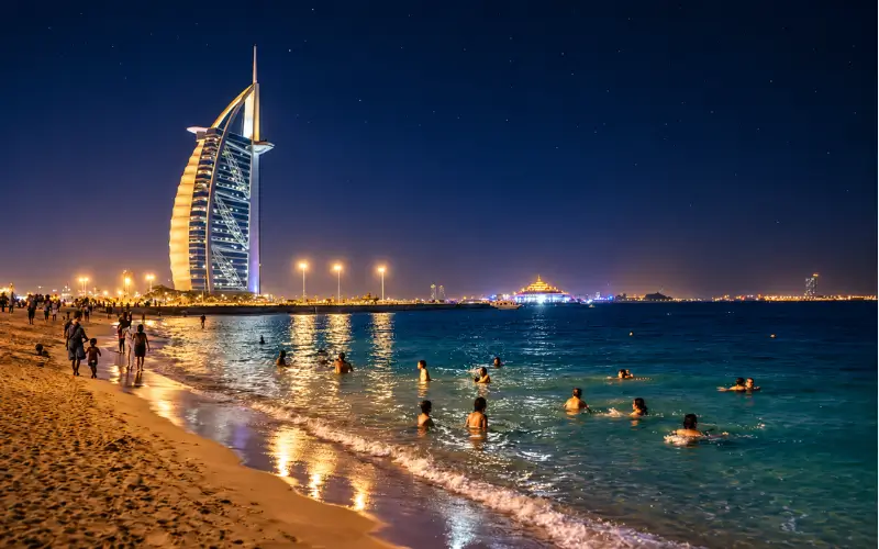 Umm Suqeim Night Swimming Beach Dubai with swimmers enjoying the illuminated sea at night