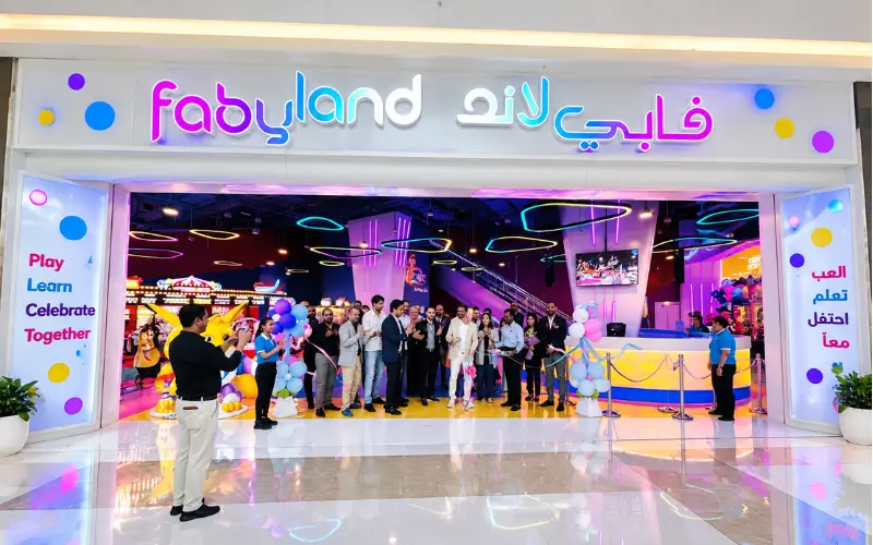 Silicon Central Mall featuring the Fabyland entertainment center with colorful neon lighting, balloons, and a festive ribbon-cutting event.